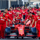 Members of the Ferrari team push the two cars out for a team photo before the final race of the 2019 season.
